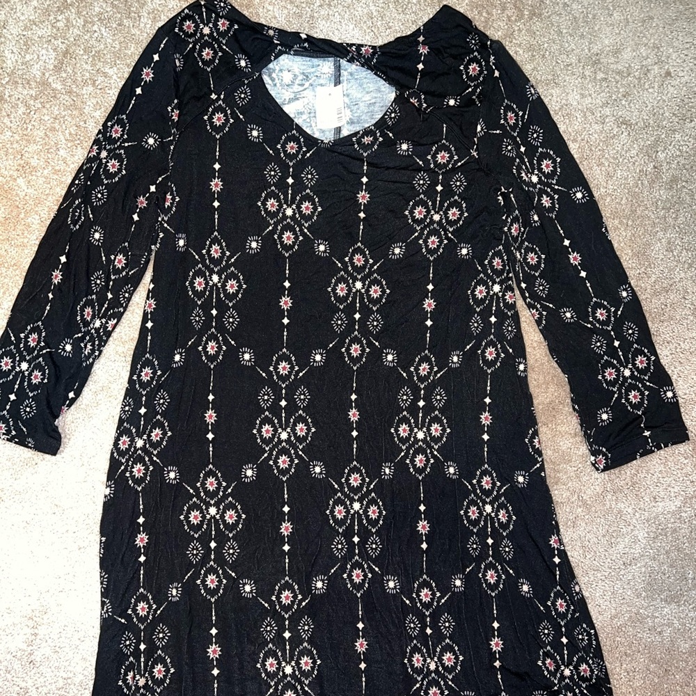 Black flowy dress. Hits around the knee. Size medium. Star design.